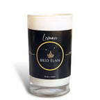 A white candle with a black label that reads 'Lemon BRIO ELAN', indicating the scent of lavender and the brand name with a white background.
